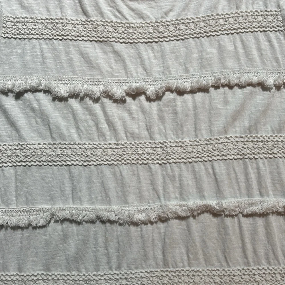 Style & Co white tee with stripes of fringe and crochet